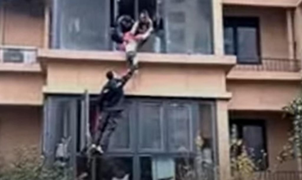 Repartidor escala edificio para ayudar a rescatar a una familia de un incendio