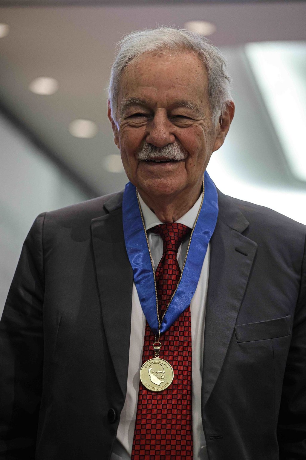 Eduardo Mendoza recibe la presea 'Carlos Fuentes' de Silvia Lemus, la viuda del autor, en la inauguración del área literaria en la FIL de Guadalajara.