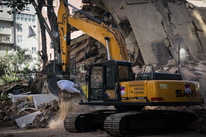 Máquina excavadora realizando labores de remoción de escombros para la búsqueda de sobrevivientes.