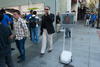 Un robot cruza frente a una fila de clientes que buscan comprar el iPhone 6.