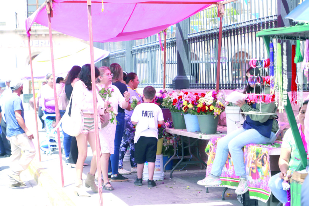 Comercio. Al exterior de la Catedral se instalaron puestos con venta de flores y artículos religiosos.
